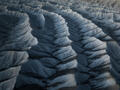 Shadowed blue-gray desert ridges form a striking rhythmic pattern across Utah’s sculpted badlands.