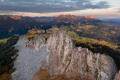 Granite cliffs rise above golden Colorado valleys at sunset in the Rocky Mountains.