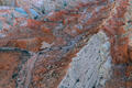 Winding desert roads cut through red and white striped Utah badlands.