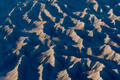 Shadowed desert ridges form rhythmic geometric patterns across Utah’s sculpted badlands.