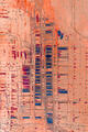 An abstract aerial of patterned earth and geometric lines resembling a vast desert circuit board.