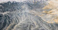 Pale gray and cream badland ridges create delicate vein-like patterns across Utah’s desert plateau.