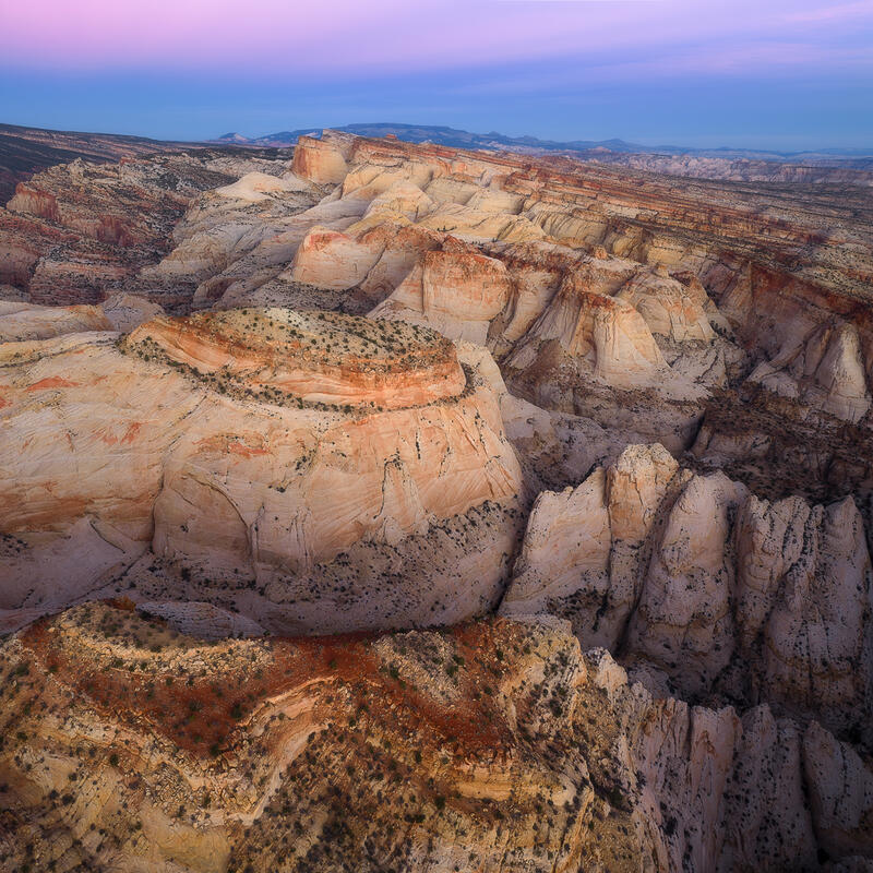 Towering cream and coral sandstone domes glow beneath soft Utah twilight skies.