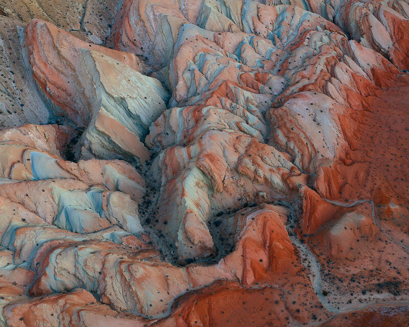 Red and teal folded Utah badlands aerial abstract landscape.