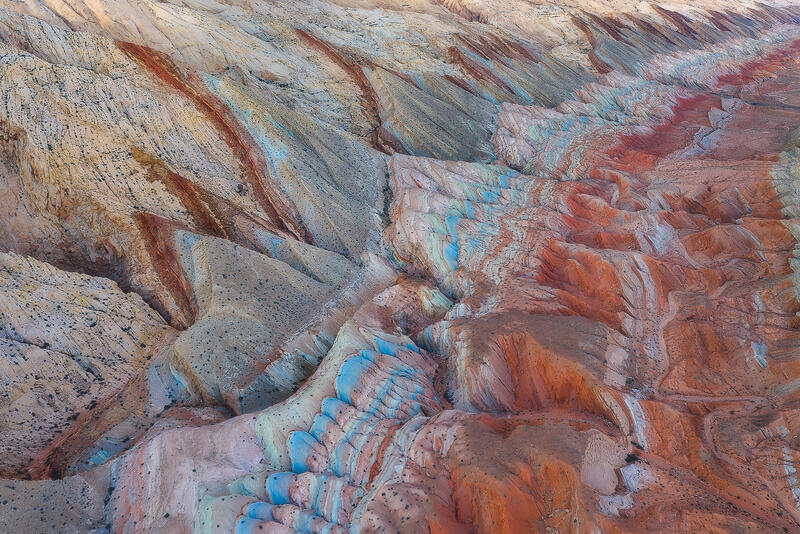 Colorful layered hills create bold patterns across Utah’s painted desert terrain.