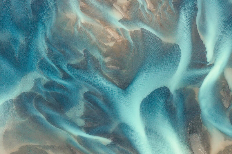 Glacial rivers flow like living arteries across Iceland's volcanic floodplains.