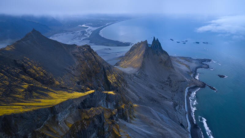 The jagged peaks of Vestrahorn rise above Iceland's dramatic Atlantic coastline in timeless morning light.