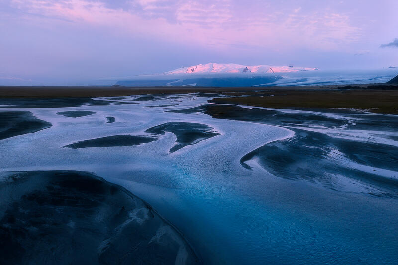 Gentle evening light transforms Iceland's braided rivers into a peaceful landscape of reflection and silence.