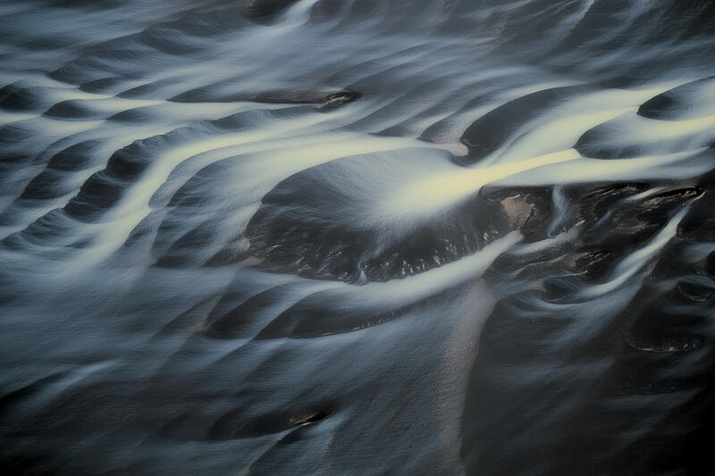 Minimalist aerial abstract of braided glacial rivers in Iceland.