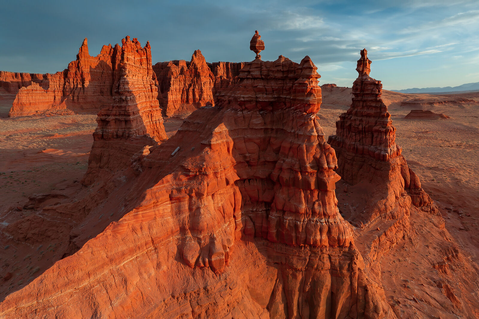 Ancient Sentinels Red sandstone towers and sculpted desert formations glowing in golden-hour light in Cathedral Valley, Utah.