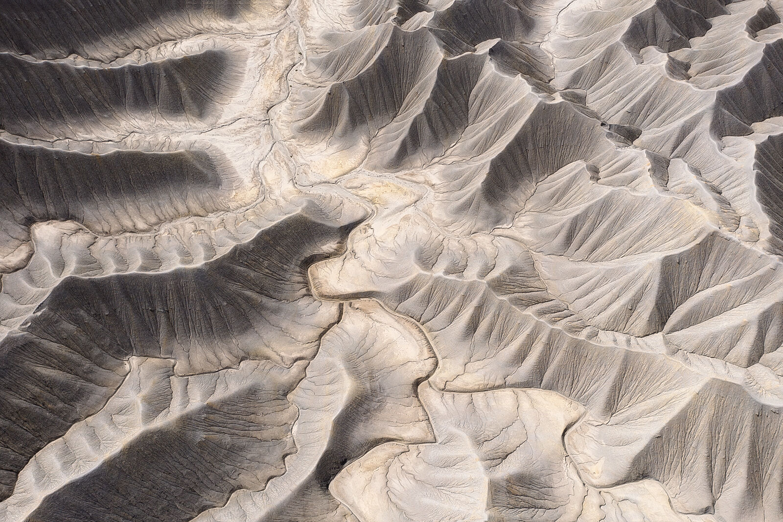 Aerial photograph of silver mountains and badlands