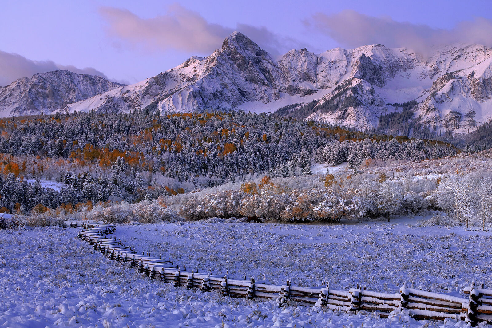 At 13,496 feet in elevation, Mears Peak stands majestically as winter starts to take hold and snow covers the last of the aspen...